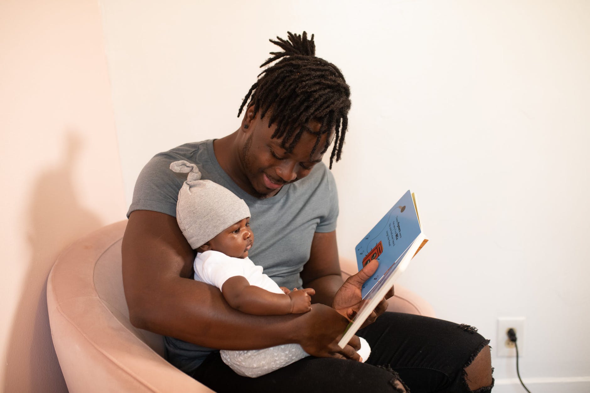 photo of man carrying baby